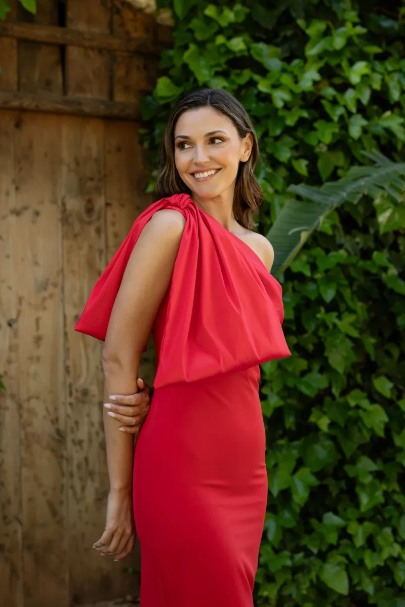 Vestido largo rojo con un maxi lazo en el hombro. Escote y espalda asimétricos.